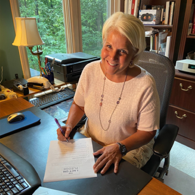 Eva Karp sitting at her home office desk.