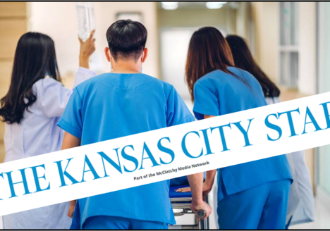 Hospital workers walking patient down hall.