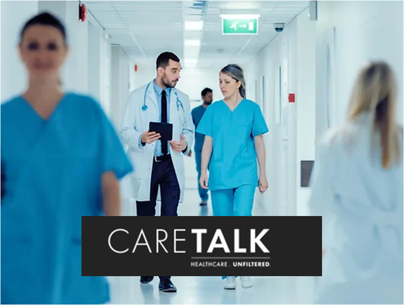 Clinicians walking in hospital hallway.