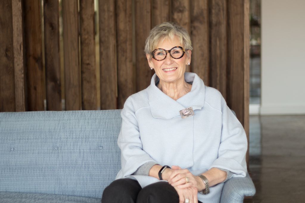 Myra Christopher sitting on a sofa.