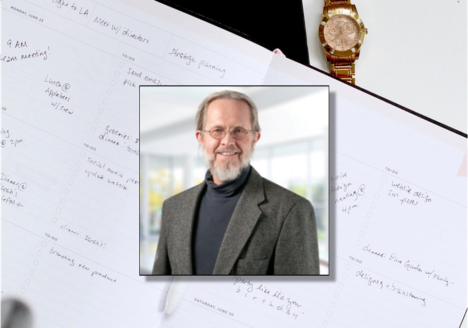 A daily planner, wrist watch, and picture of Terry Rosell.
