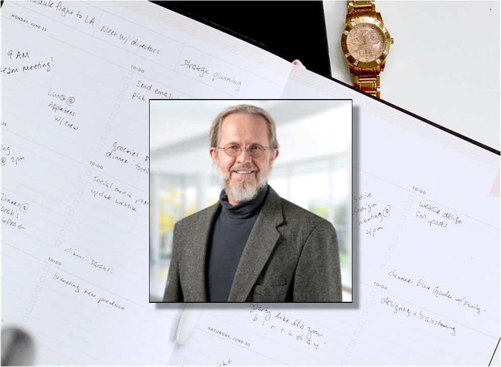 A daily planner, wrist watch, and picture of Terry Rosell.