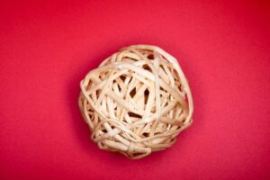 A ball of twine on a red background.