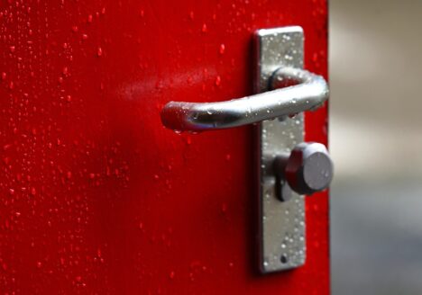 Red door to outside slightly open.