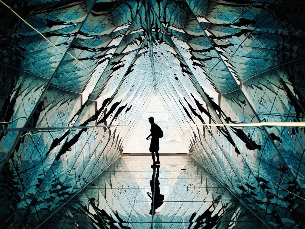 Person standing in a hall of mirrors.