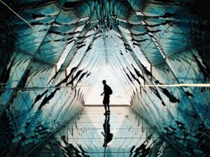 Person standing in a hall of mirrors.
