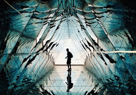 Person standing in a hall of mirrors.
