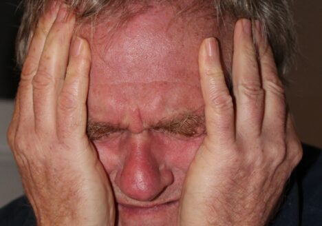 Man holding his head in pain.