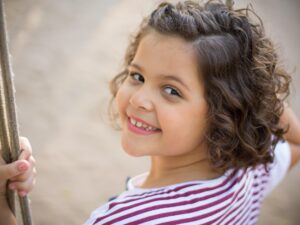 Child playing on a swing.