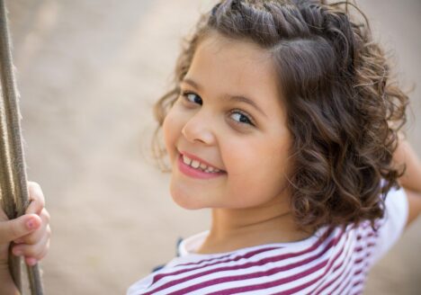 Child playing on a swing.